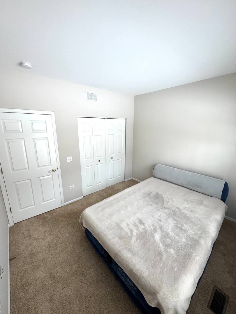 5261 Pebble Lane Crystal Lake, IL 60012 - Photo 12 of 21 a bedroom with a bed and cabinets