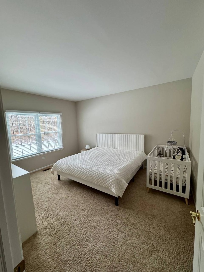 5261 Pebble Lane Crystal Lake, IL 60012 - Photo 16 of 21 a bedroom with a bed and a window