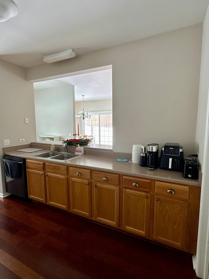 5261 Pebble Lane Crystal Lake, IL 60012 - Photo 6 of 21 a spacious bathroom with stainless steel appliances granite countertop a sink and wooden floor