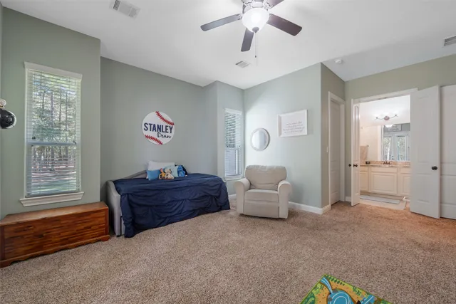 a spacious bedroom with a bed and a chandelier