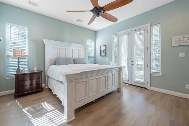 a bedroom with a bed lamp and a window