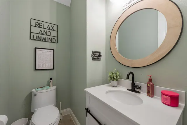 a bathroom with a toilet a sink and a mirror