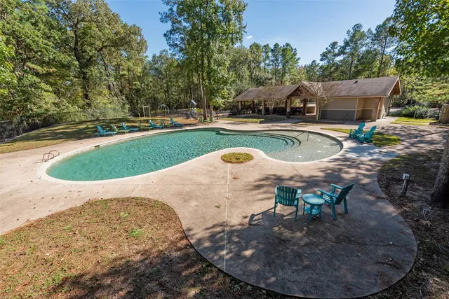a wooden bench sitting in the middle of a yard