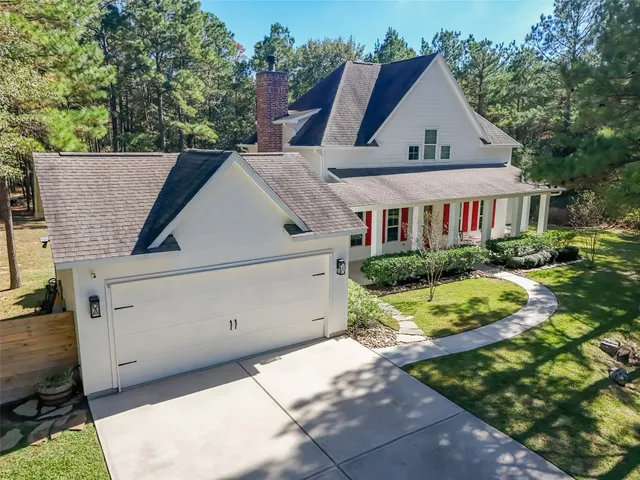 a aerial view of a house next to a yard