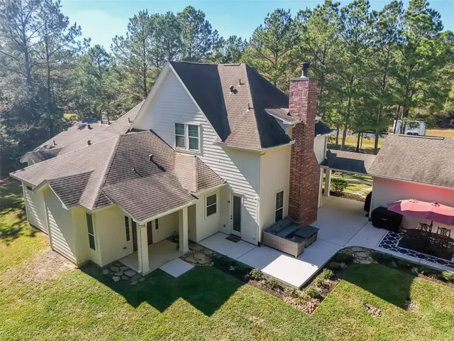 a view of a house with backyard tub and sitting area