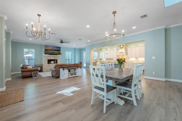 a view of a dining room with furniture wooden floor and chandelier