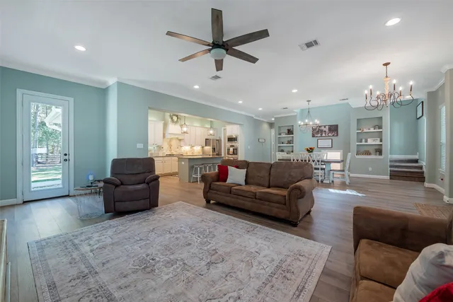 a living room with furniture and a chandelier