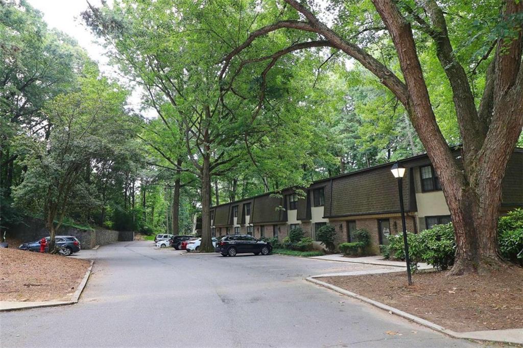 23 Arpege Way Northwest Atlanta, GA 30327 - Photo 1 of 1 a front view of a house with a yard and car parked