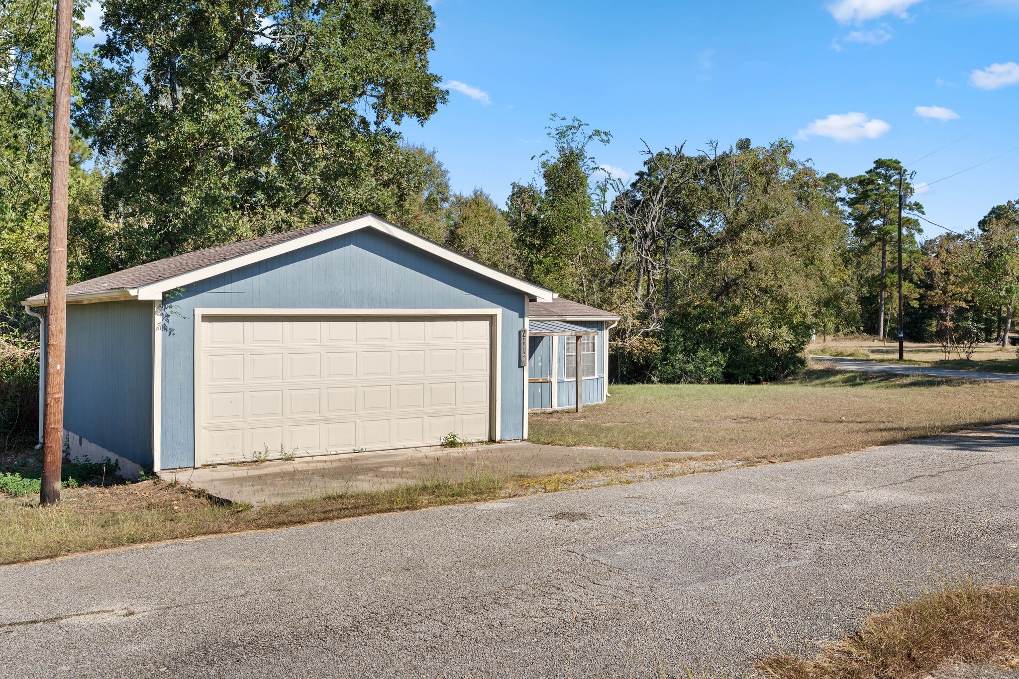 2 Tejas Street Huntsville, TX 77320 - Photo 2 of 24 a front view of a house with a yard and garage