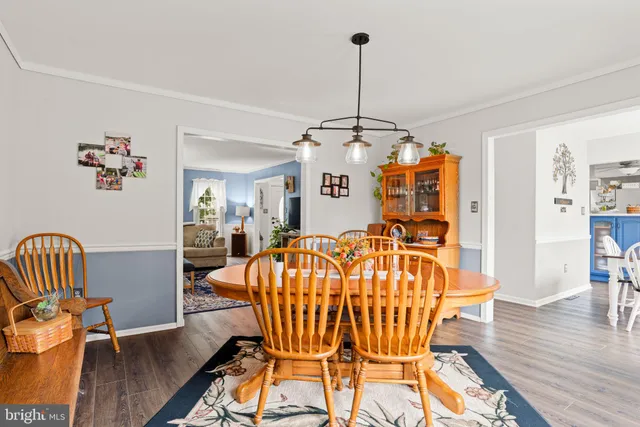 a view of a dining room with furniture wooden floor and chandelier