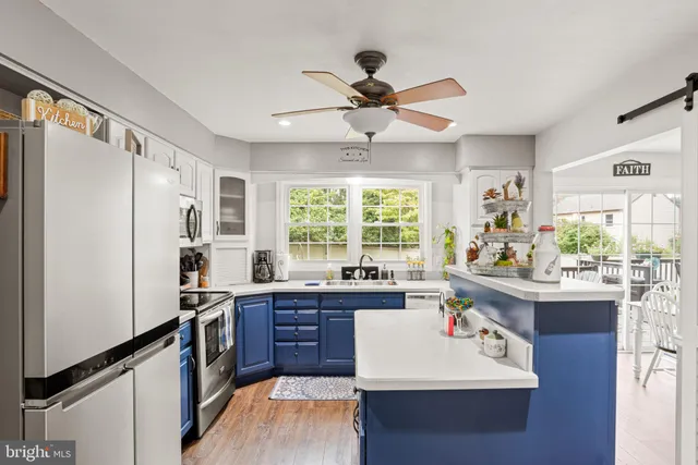 a kitchen with a sink appliances and cabinets