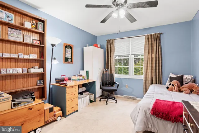 a bedroom with a workspace