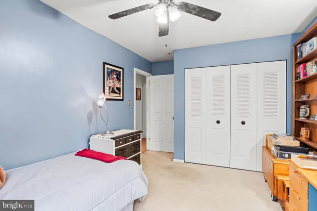 a bedroom with a bed and a book shelf
