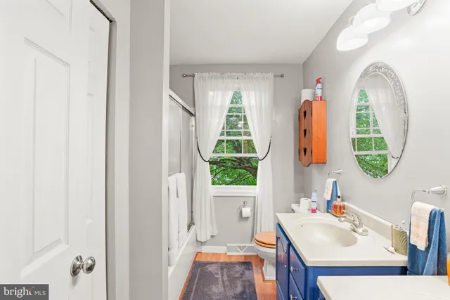 a bathroom with a sink mirror and window
