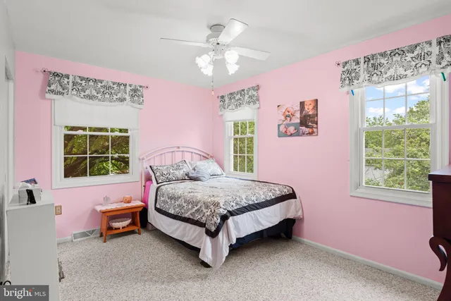 a spacious bedroom with a bed and a window