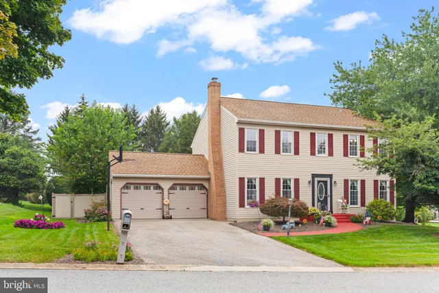 a view of a house with a garden and pathway