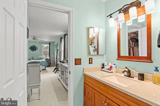 a en suite bathroom with a sink a mirror and a shower