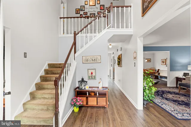 a view of entryway and hall with wooden floor