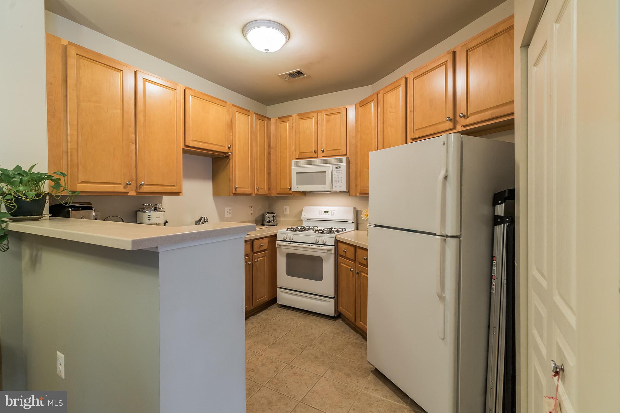 12001 Market Street, Unit 152 Reston, VA 20190 - Photo 11 of 30 Tile Floor in Kitchen * W/D in Closet to Right