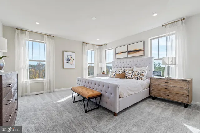 a spacious bedroom with a bed and a window