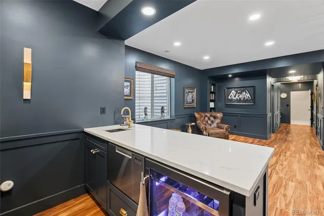 a view of a kitchen with kitchen island a sink a stove and a refrigerator