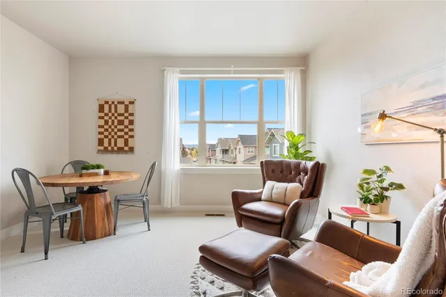 a work room with furniture and a potted plant
