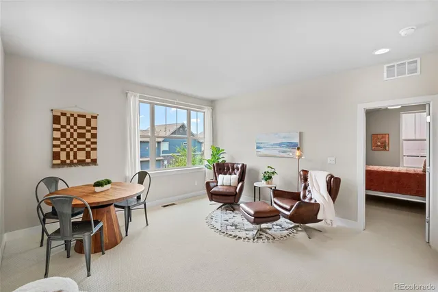 a living room with furniture a window and a table