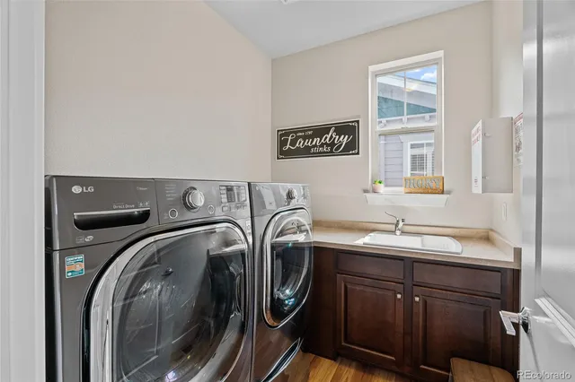 a utility room with sink dryer and washer