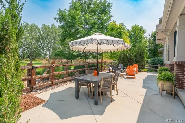 an outdoor space with patio and white umbrellas