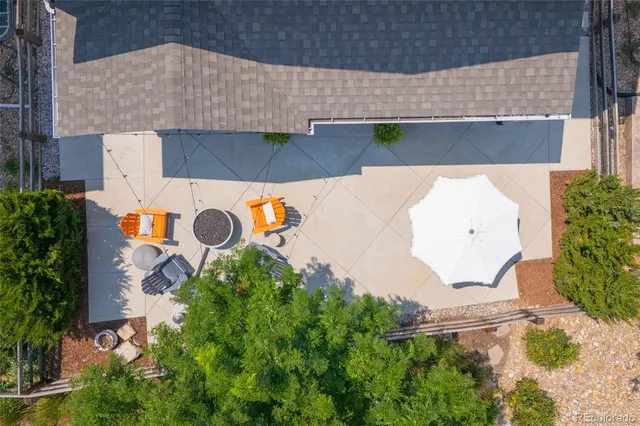 an aerial view of a house with yard and swimming pool