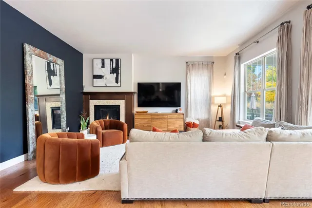 a living room with fireplace furniture and a flat screen tv