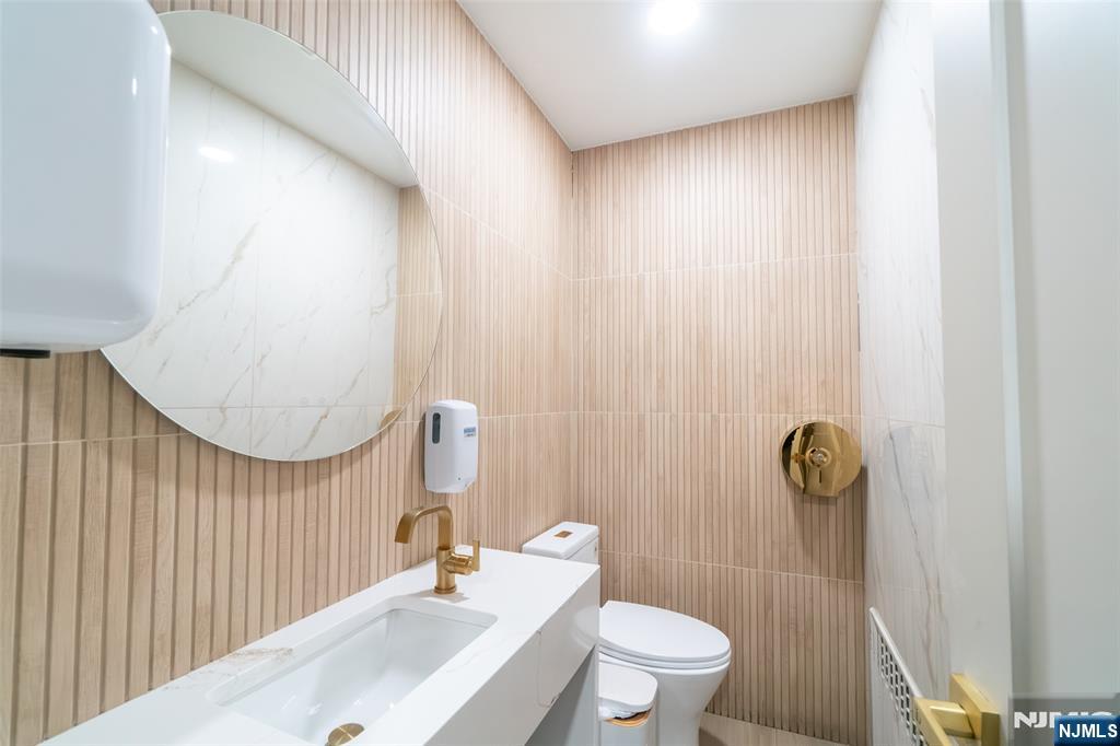 72-74 Elm Road Newark, NJ 07105 - Photo 22 of 41 a bathroom with a sink a toilet and shower curtain