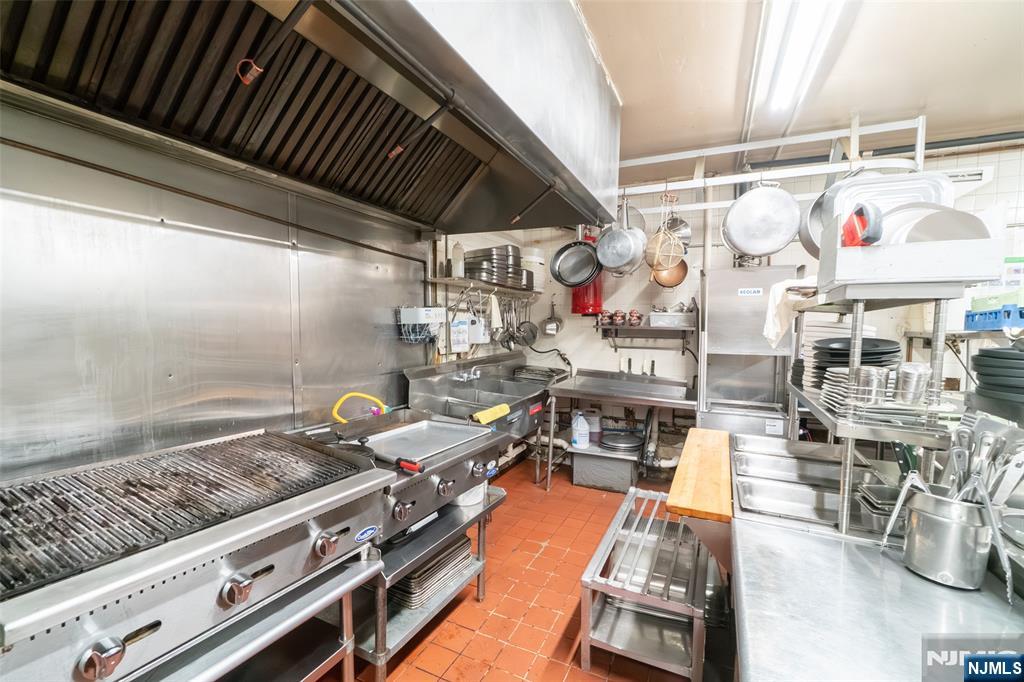 72-74 Elm Road Newark, NJ 07105 - Photo 25 of 41 a kitchen with stainless steel appliances granite countertop a stove and a sink