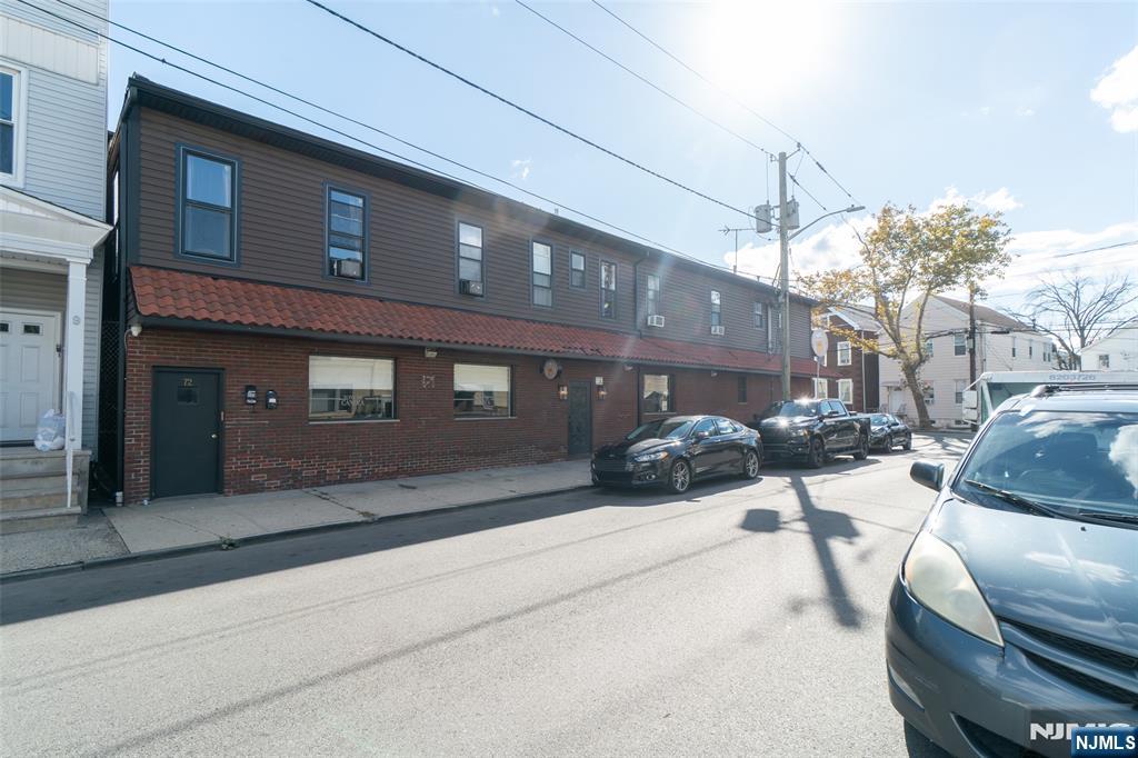 72-74 Elm Road Newark, NJ 07105 - Photo 3 of 41 a view of a building with car parked