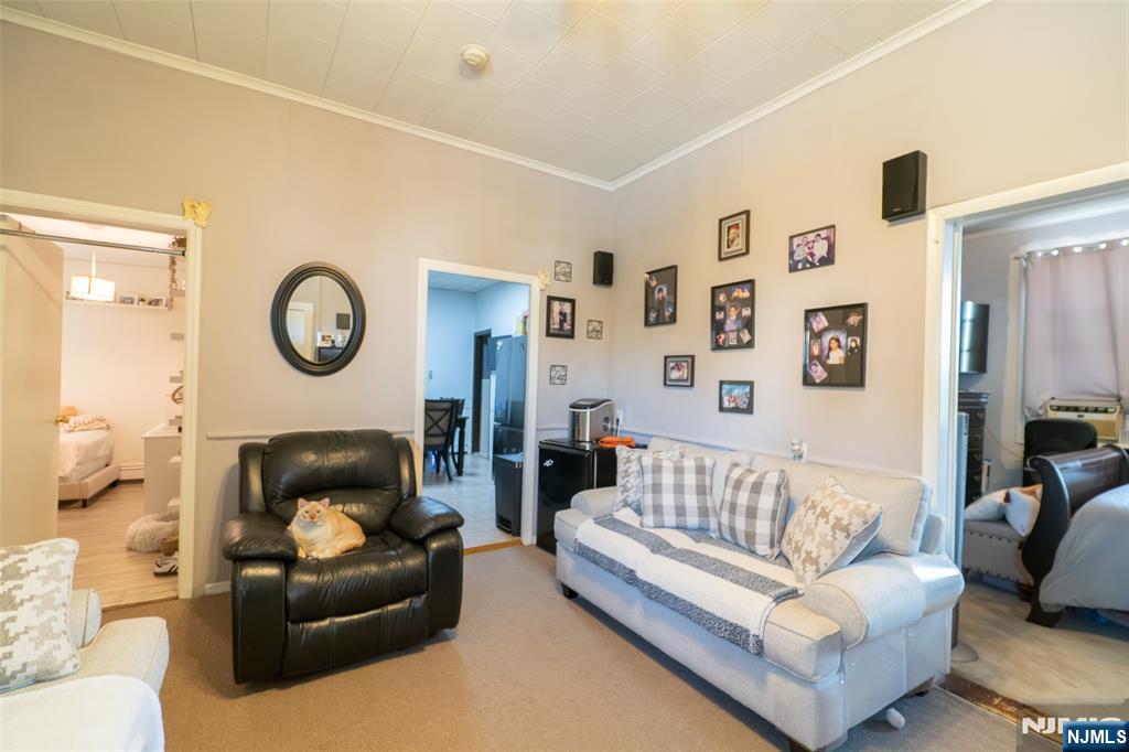 72-74 Elm Road Newark, NJ 07105 - Photo 34 of 41 a living room with furniture and a clock
