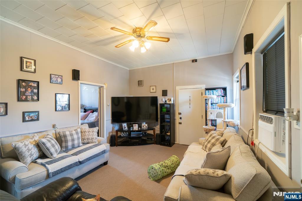 72-74 Elm Road Newark, NJ 07105 - Photo 35 of 41 a living room with furniture and a flat screen tv