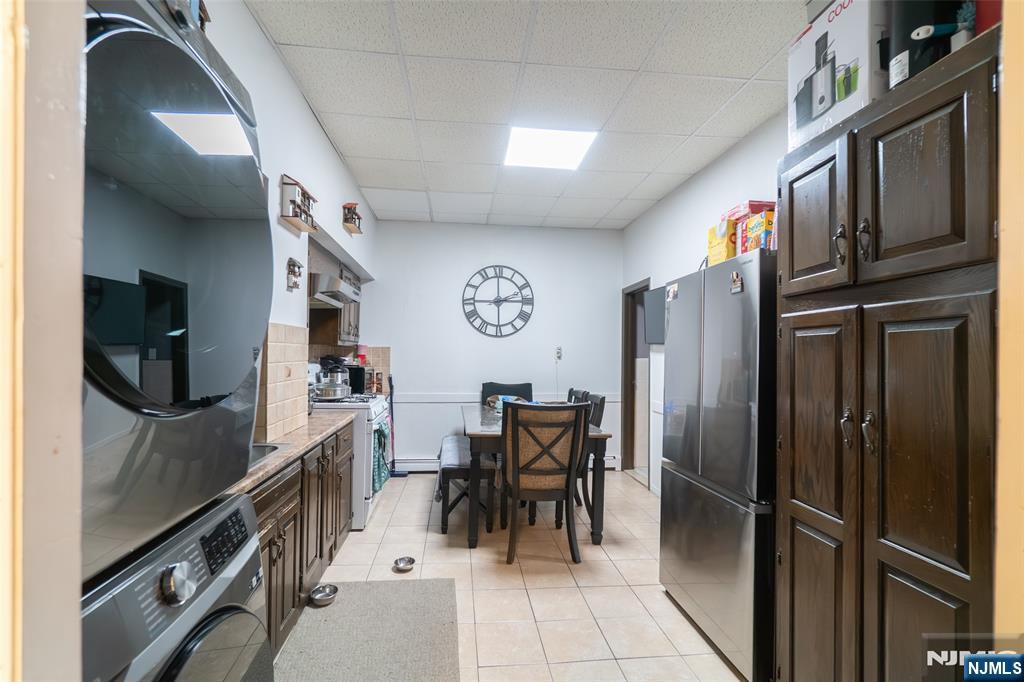 72-74 Elm Road Newark, NJ 07105 - Photo 36 of 41 a kitchen with stainless steel appliances granite countertop a refrigerator and a stove top oven