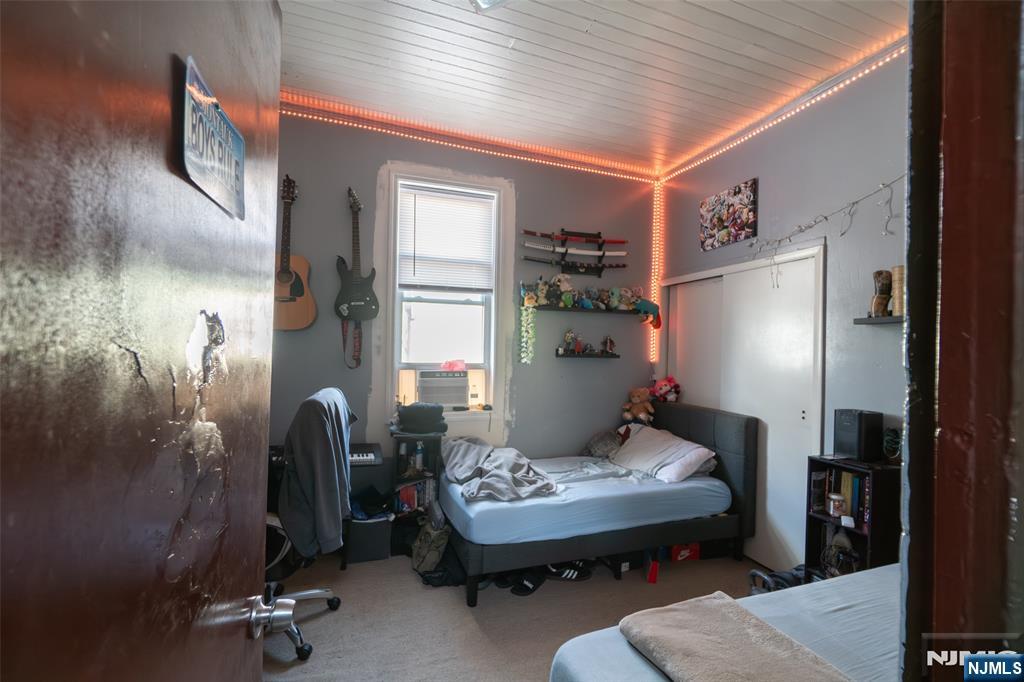 72-74 Elm Road Newark, NJ 07105 - Photo 40 of 41 a bedroom with furniture and a window