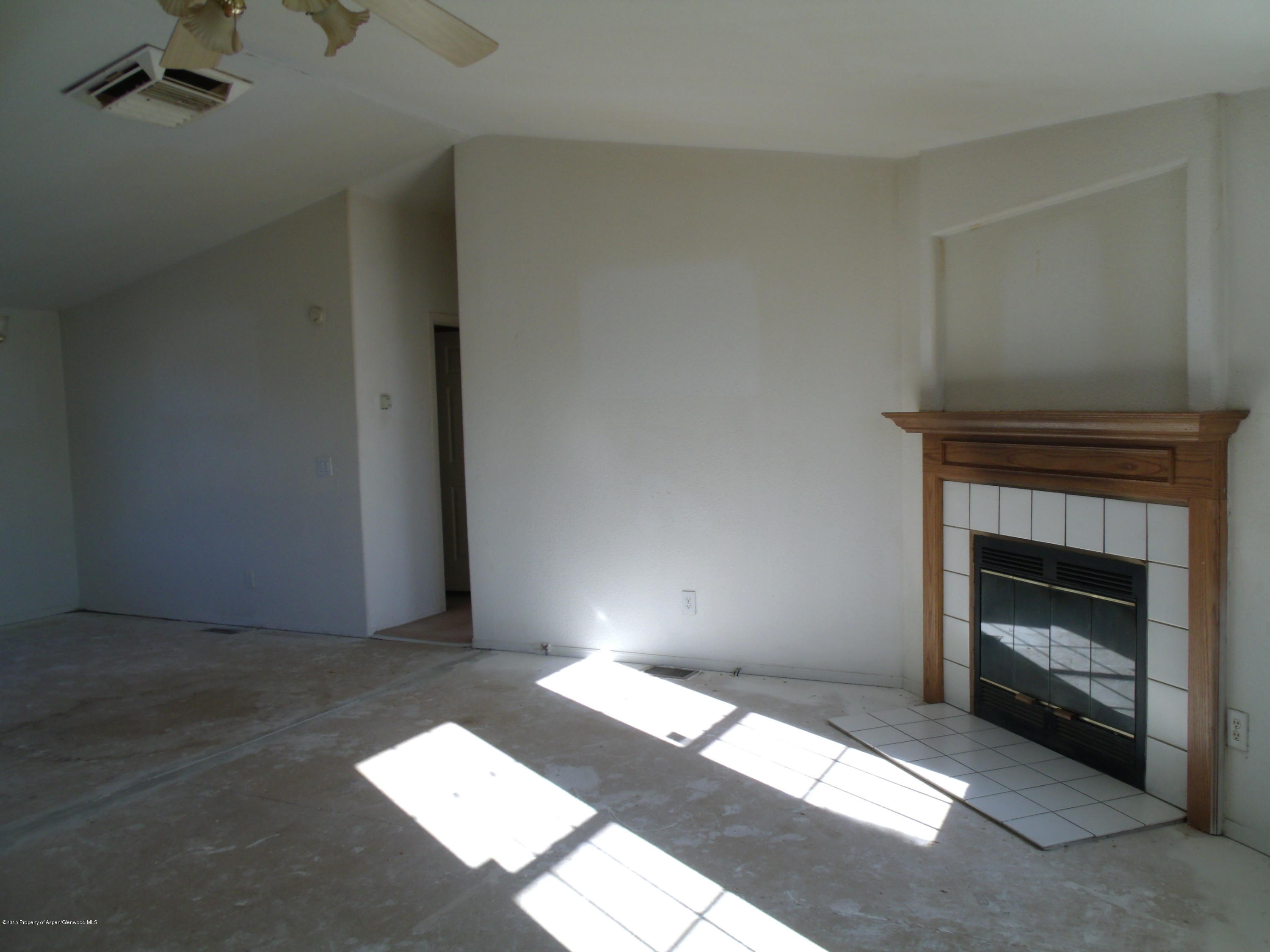 266 Fox Run Road Rifle, CO 81650 - Photo 3 of 13 a bedroom with a bed and a fireplace