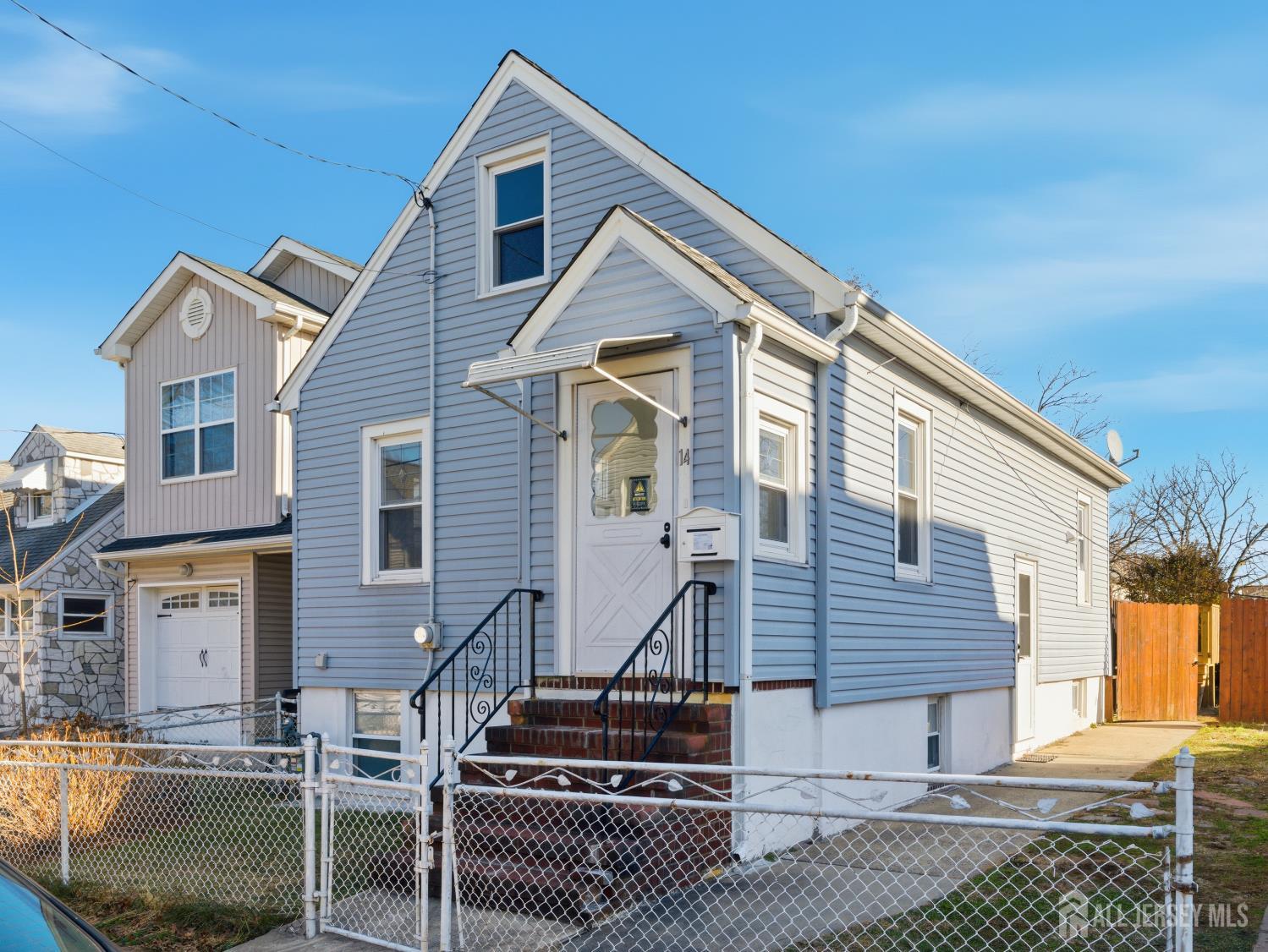 14 John Street Carteret, NJ 07008 - Photo 2 of 33 a front view of a house with stairs
