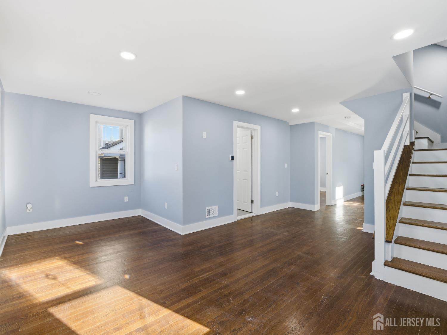14 John Street Carteret, NJ 07008 - Photo 4 of 33 a view of an empty room with wooden floor and a window