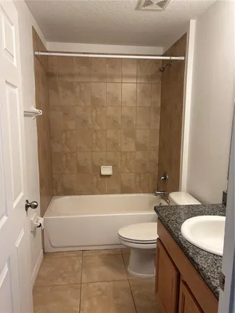 a kitchen with a sink a stove top oven and refrigerator