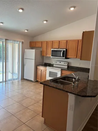 a kitchen with a refrigerator stove and microwave