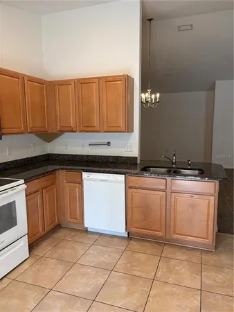 a kitchen with a sink and a stove top oven
