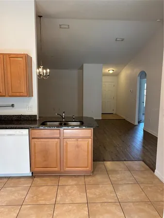 a view of empty room with wooden floor and window