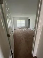 a view of a closet with wooden floor