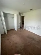 a view of an empty room with a fireplace