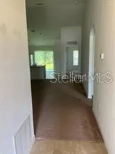 a large kitchen with stainless steel appliances a stove a microwave a sink and cabinets