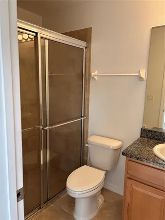 a view of an empty room with wooden floor and closet