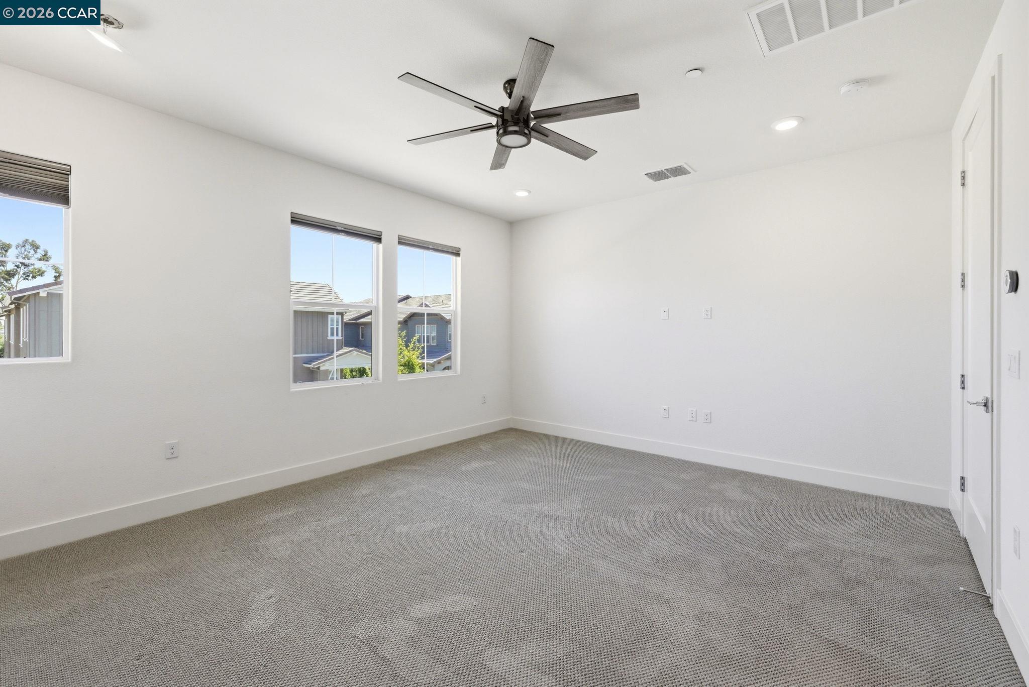205 Plum Tree Street Livermore, CA 94551 - Photo 33 of 47 an empty room with windows and ceiling fan